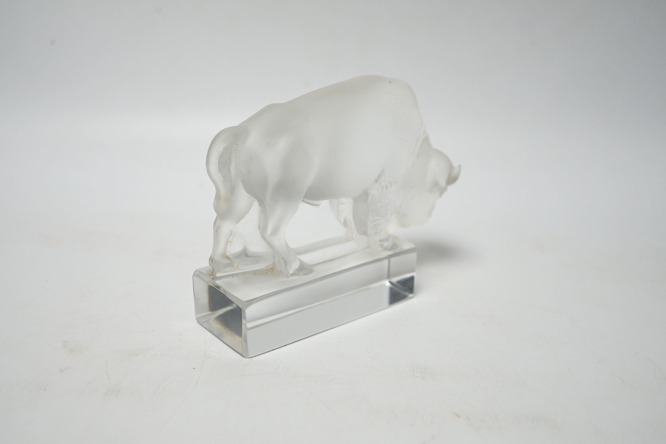 Rene Lalique, a frosted glass paperweight modelled as a bison, signed ‘Lalique France’ to base 12.5cm wide